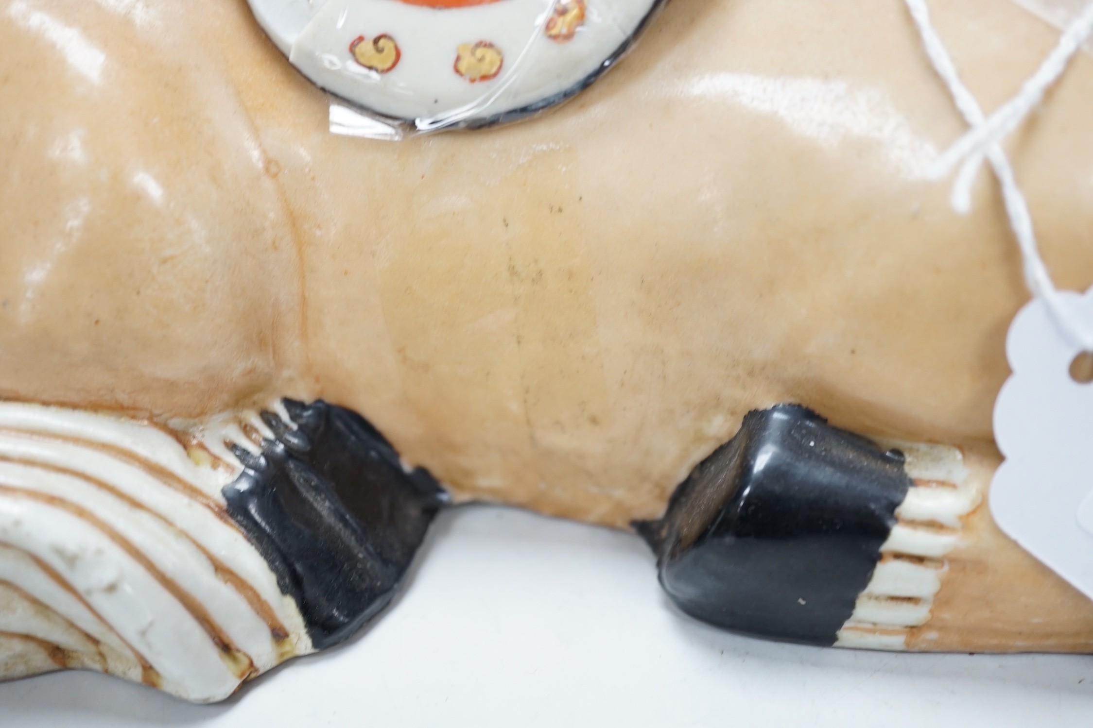 A pair of Chinese ceramic seated horses, 18cm high